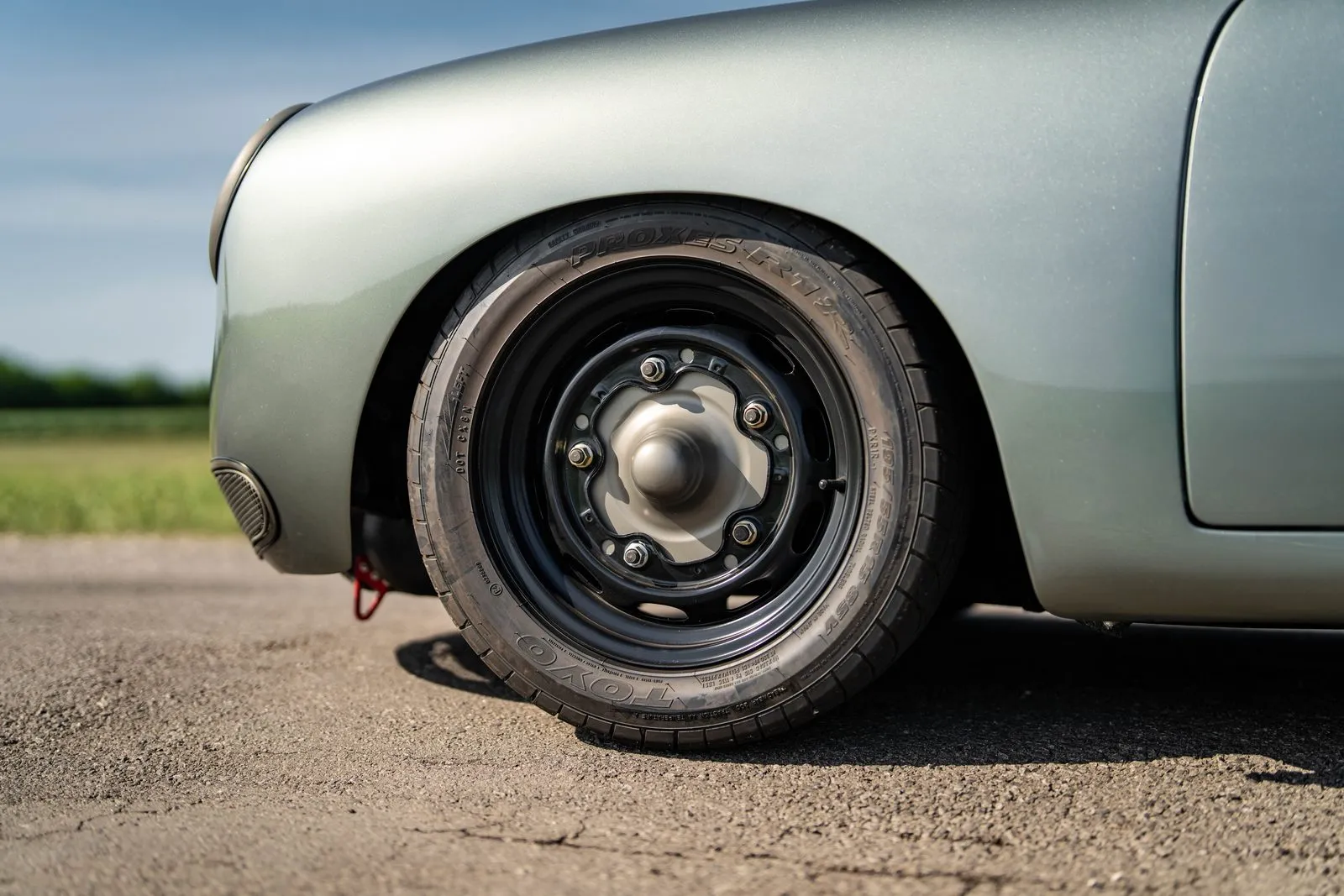 The widened wheels, painted black, framed by Cerakoted titanium trim