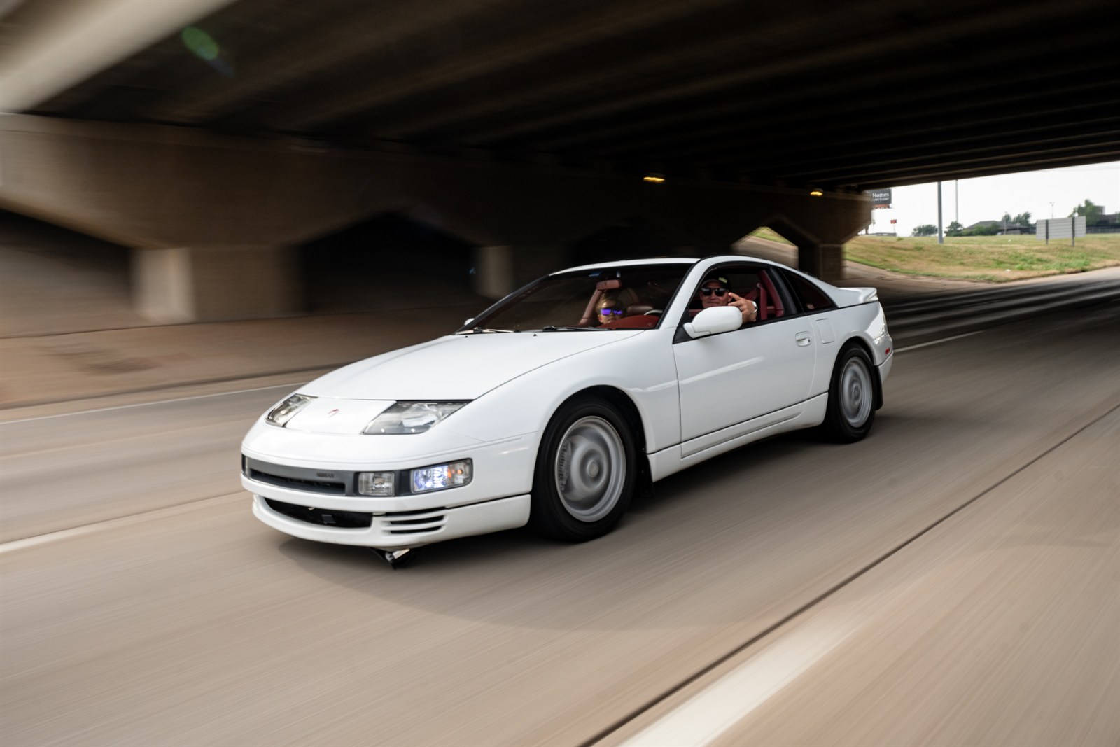Jared J-Rod Holt drives a white coupe during the memorial cruise.
